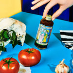 Bottle of Spicy Smoked Barbecue Sauce with hand 
