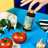 Bottle of Spicy Smoked Barbecue Sauce with hand 